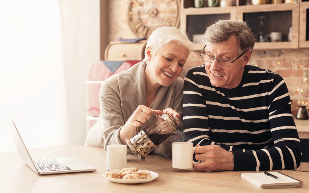 FLUFF AND TUCK happy senior couple drinking tea in the kitchen