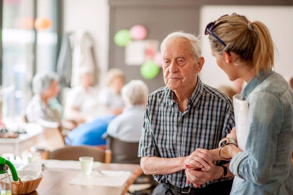 A woman and an older man navigate the five signs of dementia in a nursing home.