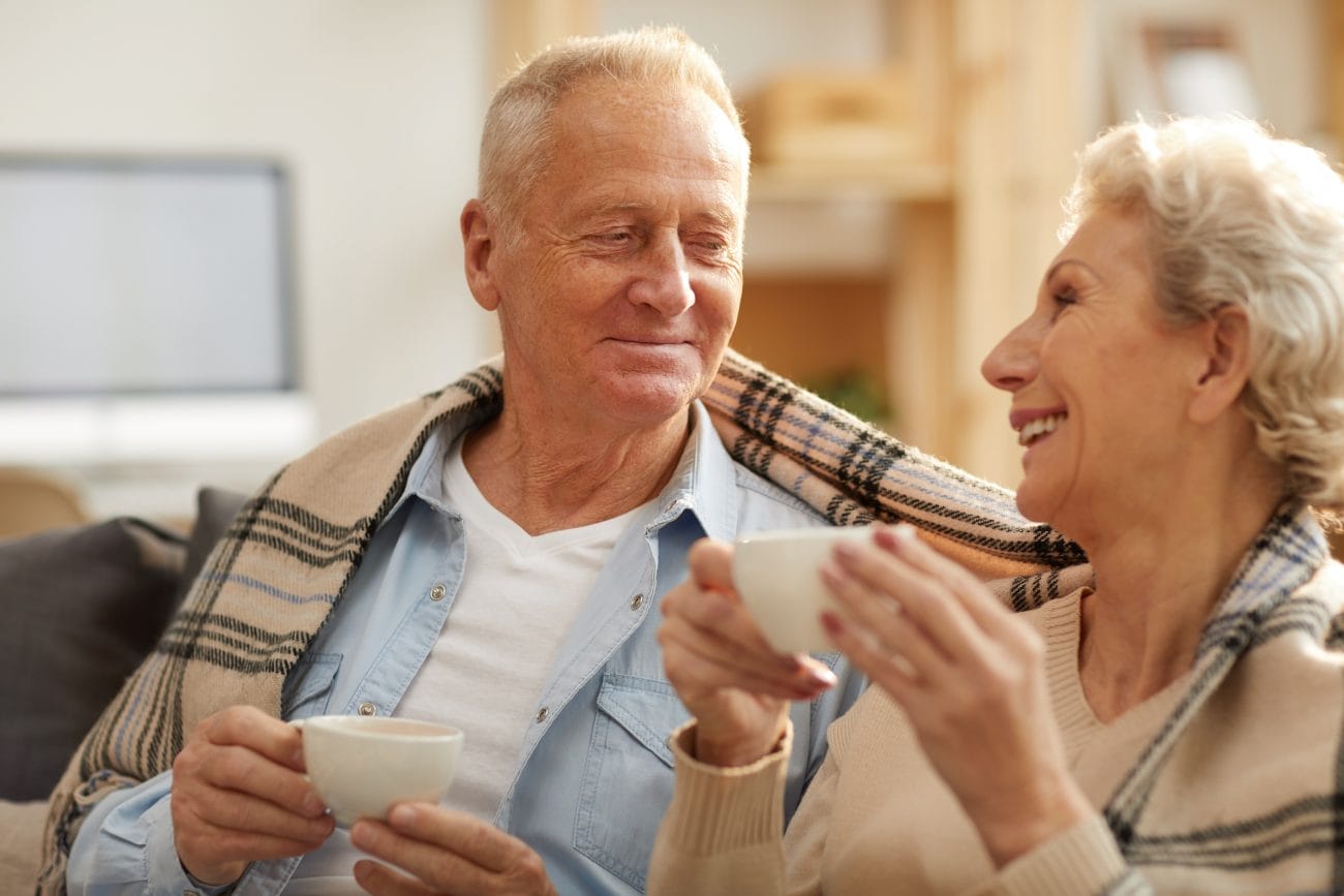 Senior couple drinking coffee at home, raising awareness for dementia.