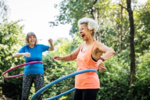 Senior woman exercising with a hula hoop