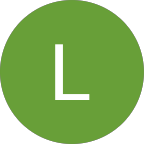 A green circle with a white, uppercase letter "L" in the center represents Home Care Columbus, symbolizing trusted home care services.