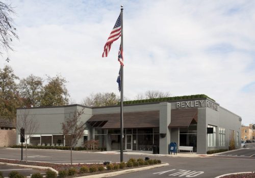 A building with an american flag in front of it.
