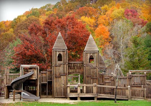 A wooden playground with a slide.